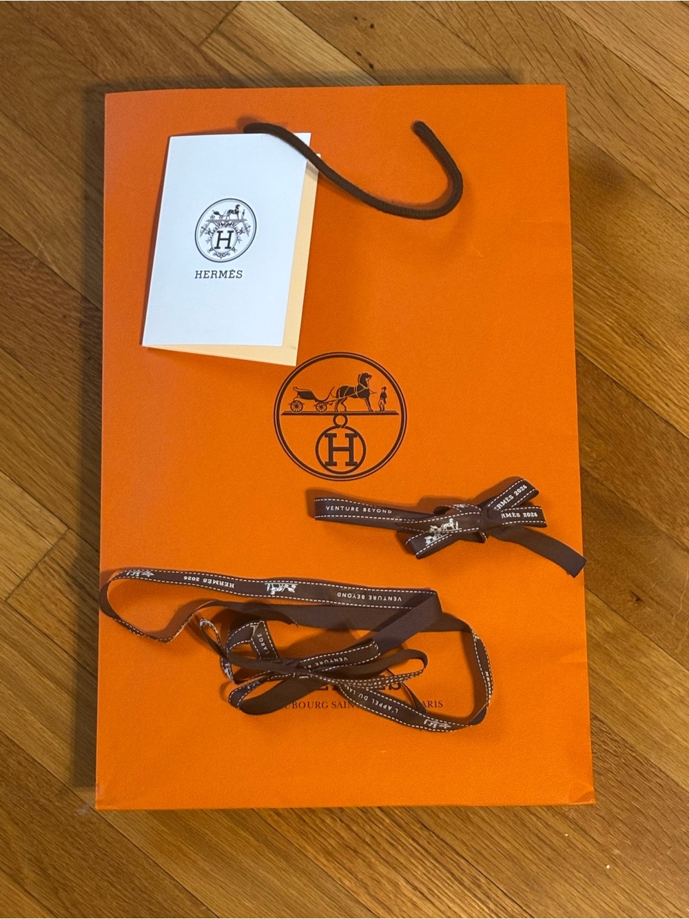 Hermes gift wrap items: gift bag, two ribbons, card insert/recipt holder